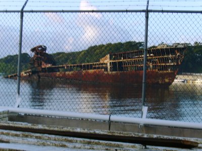 A rusted ship by the docking area