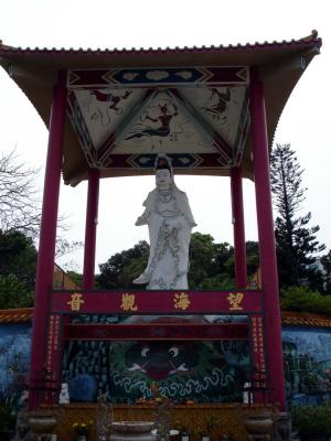 Serene, with a Mona Lisa smile, Guan Yin watches over her hillside