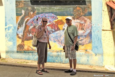 Jean and Dan in front of a mural honoring Paul Gauguin