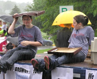 A wet pizza box helps deflect the rain
