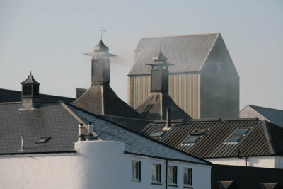 Smoke issues from the distillery turrets as the malted barley is gets its distinctive peat smoked flavour