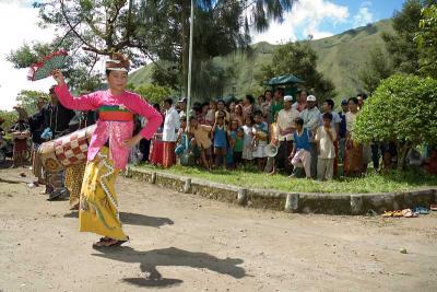 Welcoming dance, with curious village onlookers