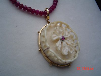 all handcarved ivory with ruby center, set in 14kt gold