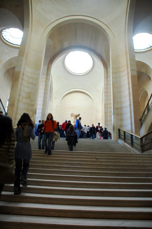 staircase with the nike of samothrace at the top.