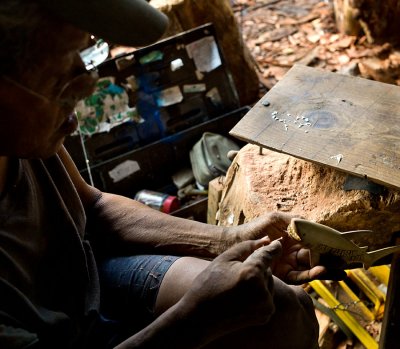 Placing shark teeth into a carved shark. L1015522.jpg