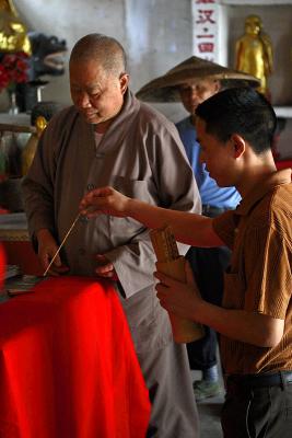 Buddhist monk preparing to tell fortune.