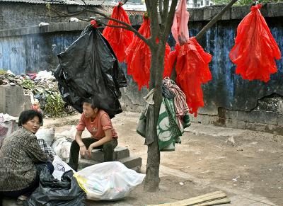 Recycling red plastic bags.
