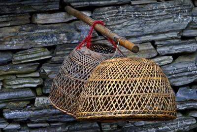 Hanging baskets. These are used for chickens or ducks with one on each end of a pole that is balanced over the shoulder.