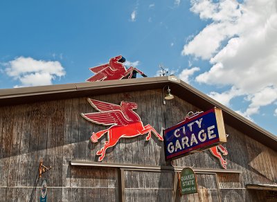 A close-up of the sign and flying horses 
