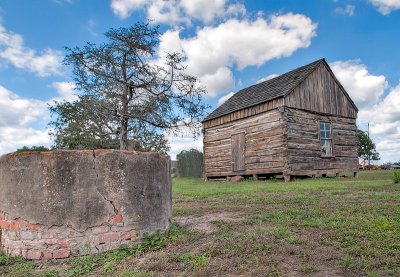 The cabin and well used by the early settlers as a school and church.