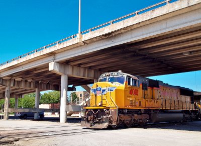 Union Pacific Engine 4018 emerges from a Highway Overpass in the Taylor TX rail yard 