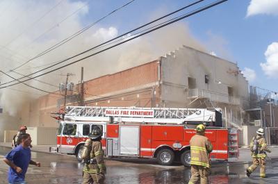 Third Hook and Ladder truck setting up  on South end of Building