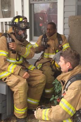 Three Firefighters who had just left the building when it was decided to get out!