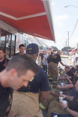 Firefighters taking a water and shade break from the heat