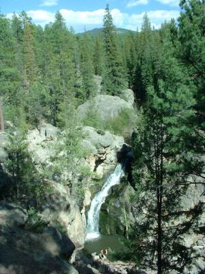 The whole Jemez Falls with swimmers