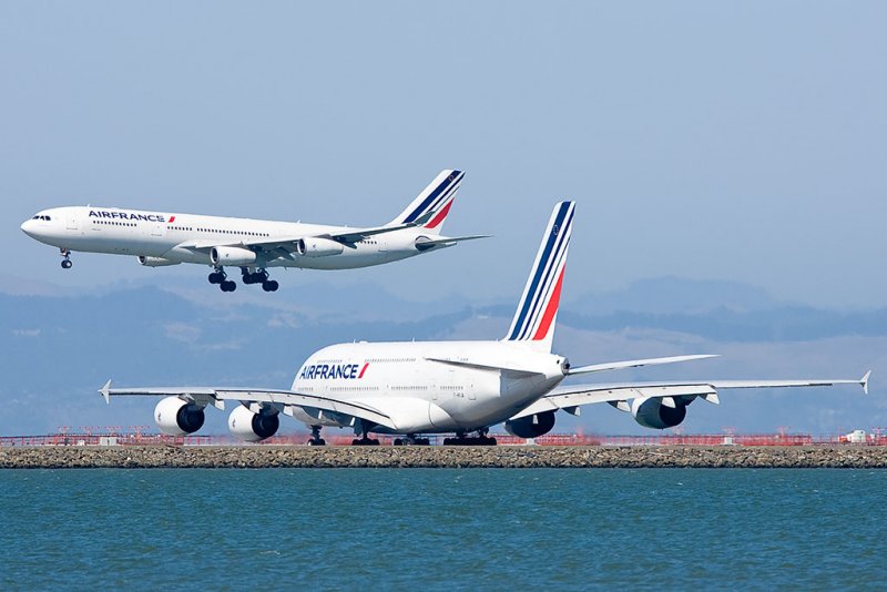 7/3/2011  Air France Airbus A340-313X F-GLZP lands as Air France Airbus A380-861 F-HPJA waits
