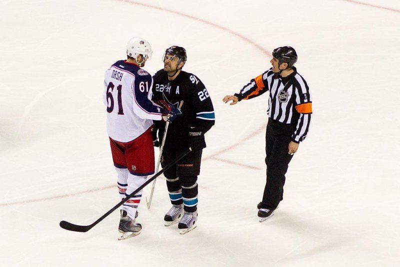 Dan Boyle is showing aggression towards Rick Nash