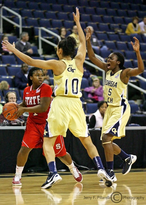 Georgia Tech G Marshall comes in to set a trap on NC State G Goodwin-Coleman