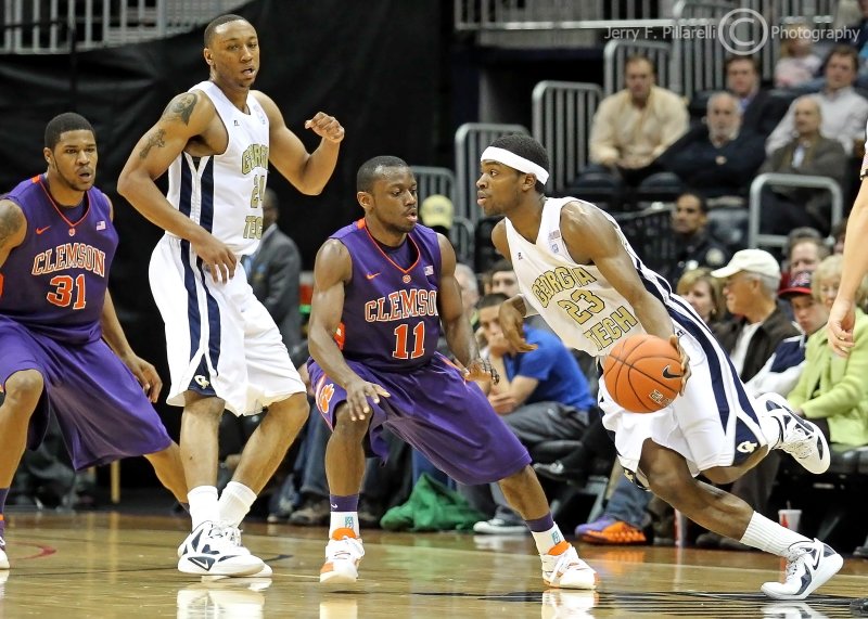 Jackets G Brandon Reed makes a move as teammate F Holsey sets a pick on Tigers G Andre Young