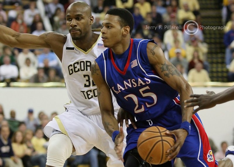 Kansas G Brandon Rush looks for help while Jackets F Smith closes in