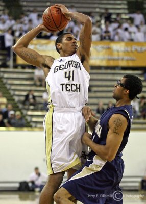 Jackets G Rice looks to pass over Mocs defender G Micah Ballard