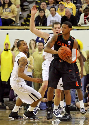 Georgia Tech C Miller gets assistance defending a Miami player from GT G Miller