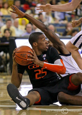 …Miami G Adams looks to pass from the sitting position after winning control of a loose ball