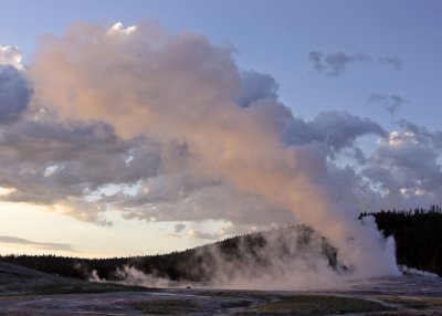 Sunset on the steam rising from Old Faithful Geyser in Yellowstone National Park
