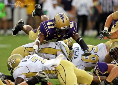 Western Carolina DB Courtland Carson dives over GT players to make a play