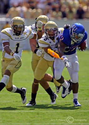 Jackets CB Peterson wraps up Jayhawks RB Sims as a penalty flag is thrown