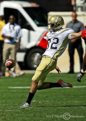 Georgia Tech P Sean Poole kicks the ball away on fourth down