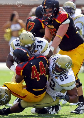 Jackets DE Jason Peters gets help from LB Steven Sylvester to bring down Terrapins RB Justus Pickett