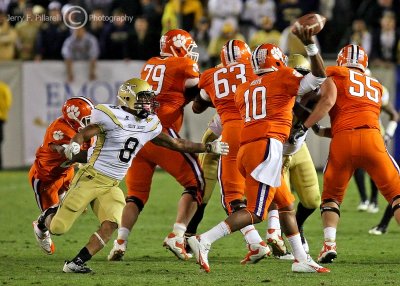 Jackets CB Louis Young blitzes around the end to get to Tigers QB Boyd