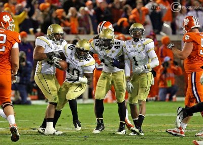 Georgia Tech LB Julian Burnett picks up a third quarter fumble…