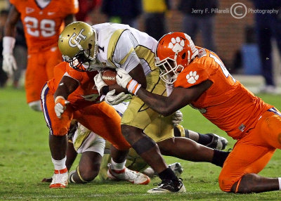 Yellow Jackets B-back Sims tries to get away from Tigers DE Branch