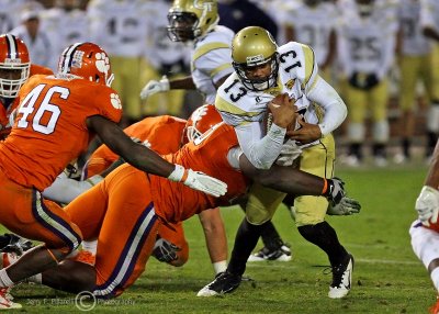 Yellow Jackets QB Washington fights his way past the line of scrimmage…