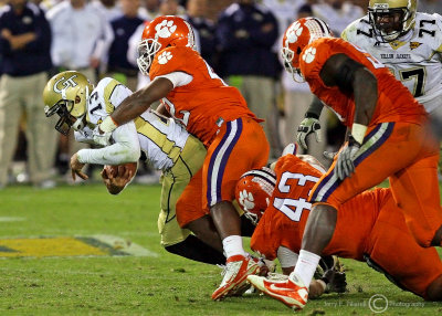 …Tech QB Washington gets wrapped up by Tigers LB Corico Hawkins