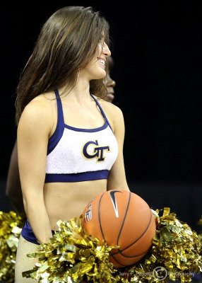 Georgia Tech Yellow Jackets Cheerleader gets a rebound