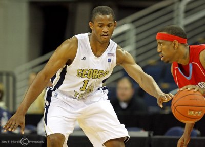 Georgia Tech G Morris watches for the pick as he guards a Delaware State player
