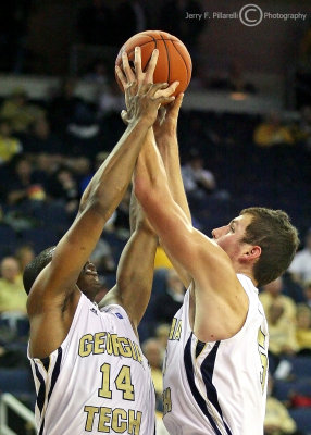 Georgia Tech G Morris and C Miller both work to secure a rebound