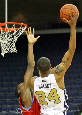 Yellow Jackets F Hosley puts up a short hook shot over a Hornets defender