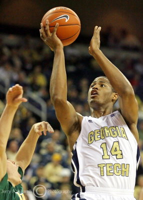 Georgia Tech G Morris lays the ball up over a Siena player