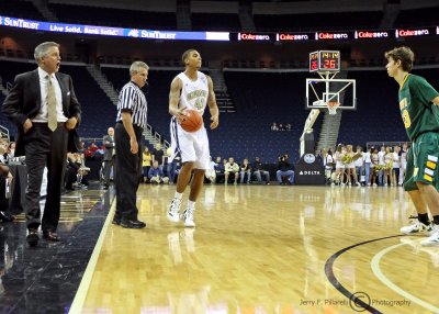 Yellow Jackets G Rice looks to make a play with Coach Gregory looking on