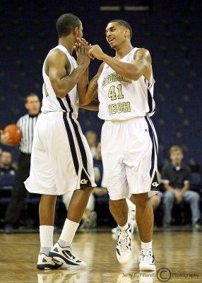 Yellow Jackets G Rice is congratulated by G Morris as he comes out of the game