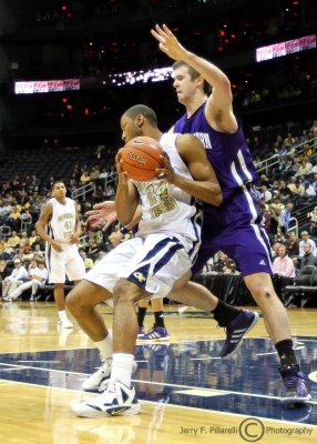 Georgia Tech F Kammeon Holsely tries to back into the paint on Northwestern F John Shurna