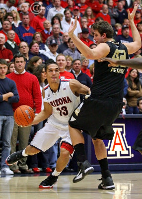 Wildcats G Nick Johnson drives around Golden Grizzly defender C Corey Petros