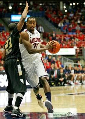 Wildcats G Kyle Fogg makes his way around Golden Grizzly G Reggie Hamilton
