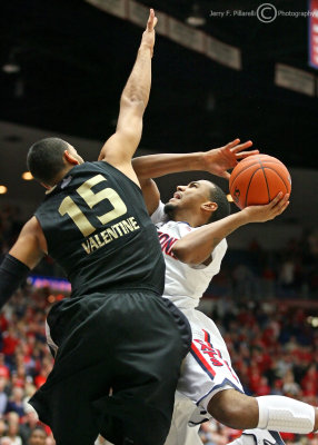 Arizona G Jordin Mayes shoots around Oakland defender F Drew Valentine