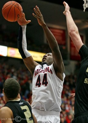 Arizona F Hill reaches to make an offensive rebound