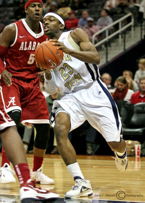 Georgia Tech G Brandon Reed drives around Alabama defenders on his way to the basket…